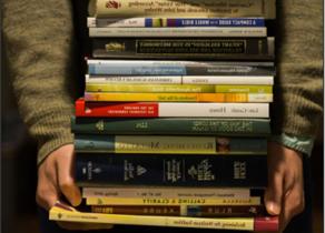 Student holding a stack of books